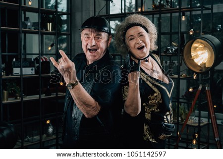 Happy couple of retirees in biker clothes.old crazy face grandmother.Merry pensioners