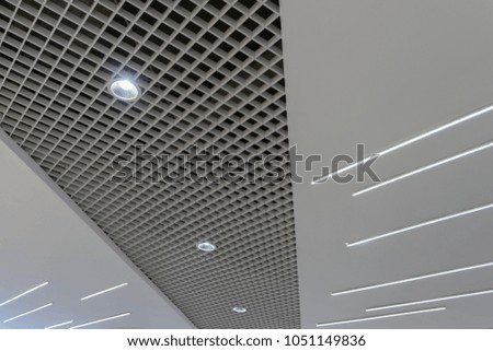 modern industrial background of aluminium stripes ceiling with light illumination