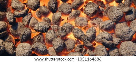Top View Of Hot Flaming Charcoal Briquettes Glowing In The BBQ Grill Pit. Abstract Red Black Background, Texture Or Wallpaper. Burning Coals For Cooking Barbecue Food. Close Up. Web Banner