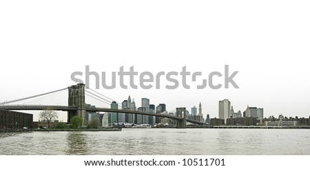 Panoramic view of Brooklyn bridge, lower Manhattan and financial district, New York. White sky for copyspace.