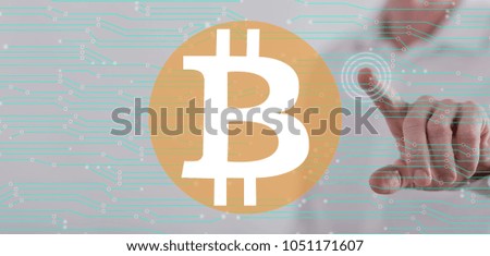 Man touching a bitcoin concept on a touch screen with his finger