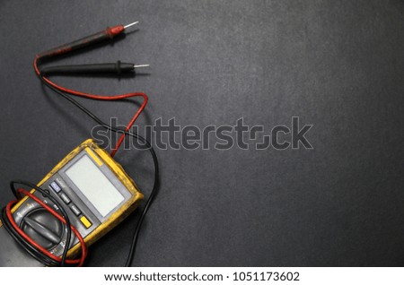 Multimeter on Black table background Top view copy space