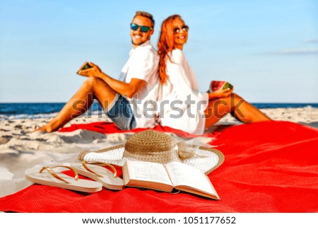 Beach towel of free space for your product and two lovers on sand. Summer day with sea landscape. 