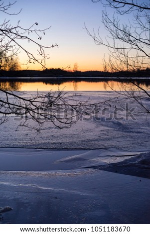 Beautiful nature and landscape photo of spring evening in Sweden Scandinavia. Nice colorful outdoor photo with lake and ice at sunset. Calm, peaceful, joyful and happy background photo. 