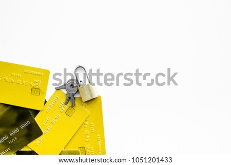 Electronic payments protection. Bank cards near lock and keys on white background top view.