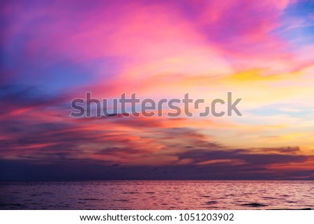 Tropical colorful dramatic sunset with cloudy sky . Evening calm on the Gulf of Thailand. Bright afterglow.