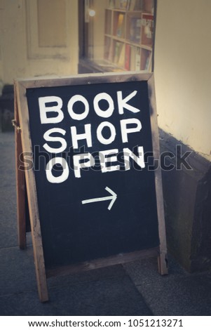 Book Store Open Message on Chalkboard in Front of Book Shop in Glasgow, Scotland, UK