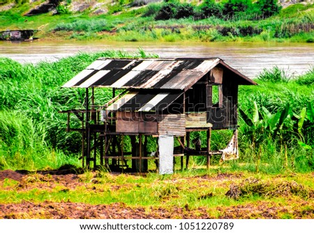 A tin shack by a river 