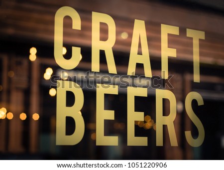Craft Beers Sign in Pub Window With Reflection of Lights in Glasgow,  Scotland
