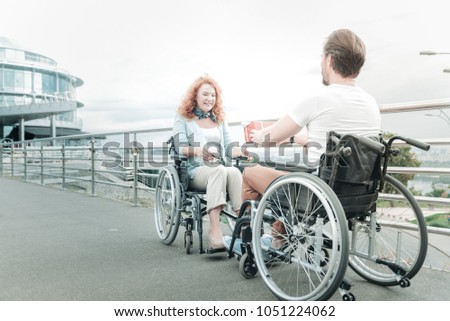 For you. Relaxed handicapped people looking at each other while spending time together outdoors