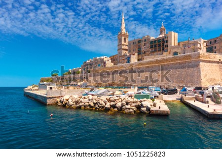 Valletta Skyline with fortress wall, boat pier and St. Paul's Anglican Pro-Cathedral, Valletta, Capital city of Malta. View from the sea