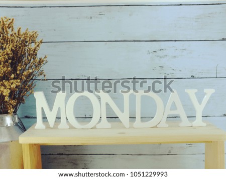 decorative letters word monday with dried flowers on wooden background