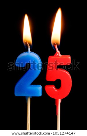 Burning candles in the form of 25 twenty five figures (numbers, dates) for cake isolated on black background. The concept of celebrating a birthday, anniversary, important date, holiday, table setting