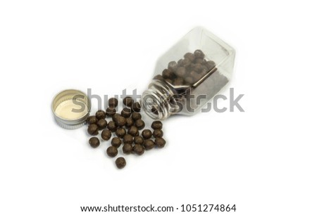 Pile of Bolus and transparent bottle.bolus (from Latin bolus, "ball") is a ball-like mixture of food and saliva that forms in the mouth during the process of chewing, the administration of a drug, Royalty-Free Stock Photo #1051274864