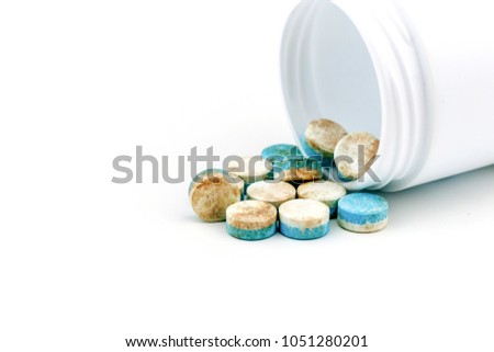 Blue & white pills medicine the drug expired.on white background / Do not use it strictly /  healthy eating for bad life. Royalty-Free Stock Photo #1051280201