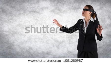 Digital composite of Business woman blindfolded with grunge overlay against white wall