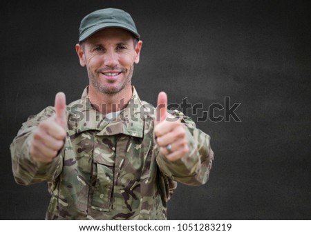Digital composite of Soldier thumbs up against grey wall