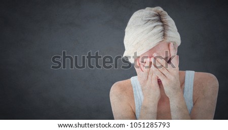 Digital composite of Woman crying in hands against grey background with grunge overlay
