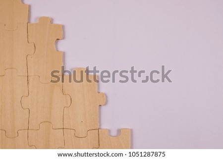 Texture / background of a puzzle made of wood. Half built.