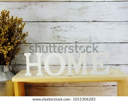 decorative letters word home with dried flowers on wooden background