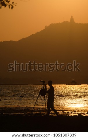Sunset photographer shooting buddha landscape silhouette
