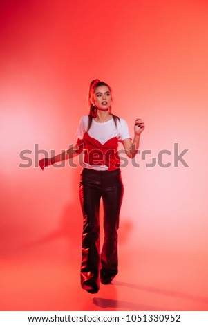 toned picture of fashionable young woman in stylish clothing looking away