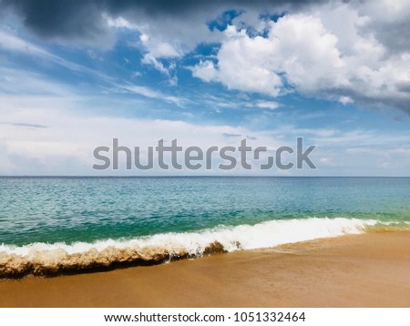 Under the bright and shiny sky, the beautiful breaking of water surface waves on a coastline. Sea, sand, sky is always my favorite.