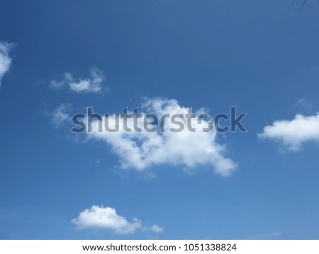 Blue sky background with white clouds.