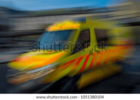 Ambulance on the road.
The ambulance turned to the bend at high speed, blurred motion.
 Royalty-Free Stock Photo #1051380104