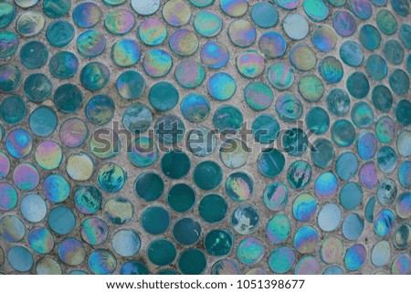 Colorful mosaic tiles pattern on a concrete wall. Mosaic background for exterior or interior