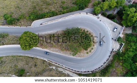 Medium altitude aerial photo hairpin turn also called hairpin bend hairpin corner named for its resemblance to hairpin bobby pin is bend in road with a very acute inner angle vehicles driving up Royalty-Free Stock Photo #1051419071