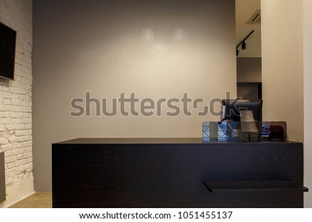 fashion boutique interior, furnished without clothes with empty shop display, clean and new designed interior. cashier terminal. Royalty-Free Stock Photo #1051455137