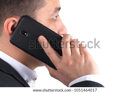portrait of serious young attractive man in black suit talking on mobile phone, isolated on white background.