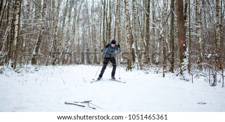 Photo of male skier in gray jacket