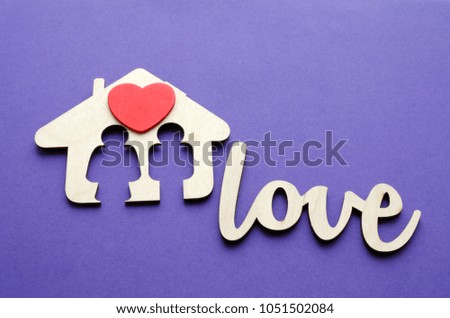 family house with red heart over ultraviolet background