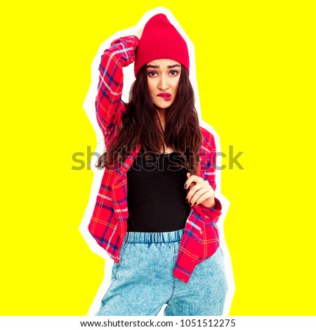 Stylish brunette Girl. Urban Fashion Look.  Checkered shirt, jeans and beanie cap
