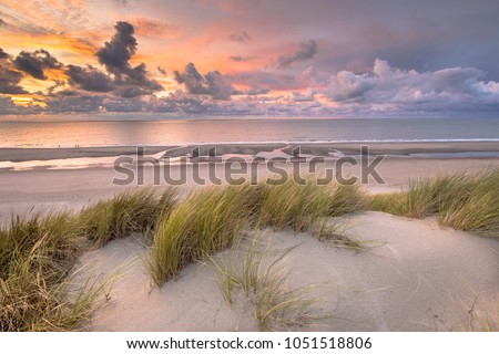 Sunset View from dune top over North Sea and Canal in Zeeland, Netherlands Royalty-Free Stock Photo #1051518806