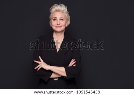 Elegant blonde beautiful middle aged lady posing,smiling to the camera. Attractive businesswoman.