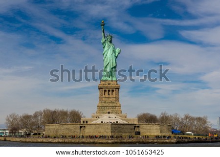 Front view of The Statue of Liberty on Liberty island with blue sky background, Landmarks of New York City, USA