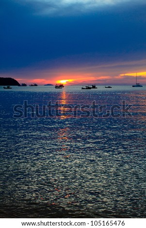 Fishing boat at sunset , Pattaya beach, east of Thailand