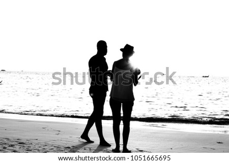 Lovers are taking photos. The evening is falling. And sweet love. Light and shadow are black and white as the background.