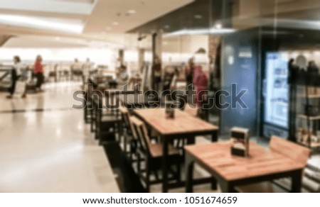 Abstract blurred image of people in shopping mall with bokeh, vintage color.