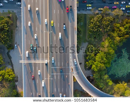 aerial shot of super highway traffic with cars and busy roads in day time