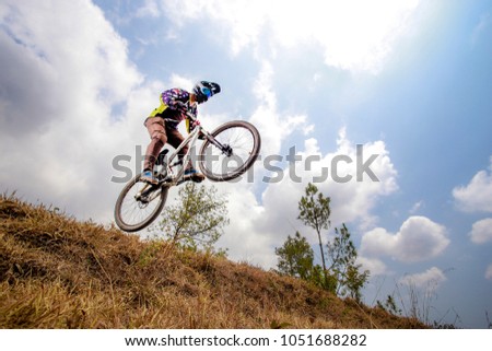 jump with downhill mountainbike at downhill trail Royalty-Free Stock Photo #1051688282