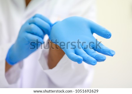 scientist wearing glove. Royalty-Free Stock Photo #1051692629