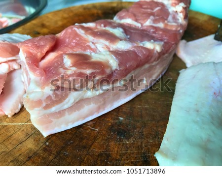 Fresh pork was sliced with vintage knife on wood 