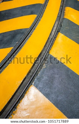 Industrial striped road or step warning railway. yellow-black pattern.