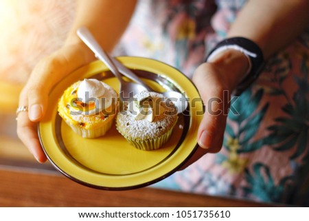 Women eating cupcake in the breakfast 