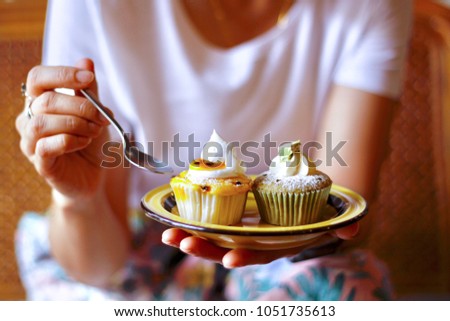 Women eating cupcake in the breakfast 