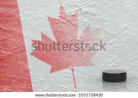 Hockey puck and Canadian flag on ice. Concept, hockey